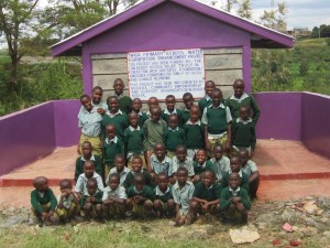 Inscription on the latrine wall reads " Twiga Primary School water & Sanitation enhancement project. This project has been funded by CanAssist African Relief Trust in conjunction with the Grey Gates Foundation /Vancouver and the family of Ruth and Donald Redmond."