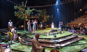 The bare thrust stage at the Festival Theatre converted to a summer garden party for Midsummer Night's Dream.  As the audience came in, actors as partygoers, mingled and chatted with them. 
