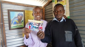 Benta Odihambo's sons, Blasto and Samwel accept the donation from the St Mark's congregation in Barriefield to purchase sanitary pads for the older girls at the school.