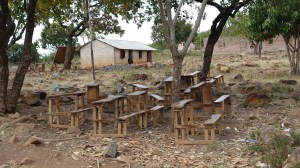 Some classes at this school are held outside. It is better than the classroom that is hot and dirty and crowded.